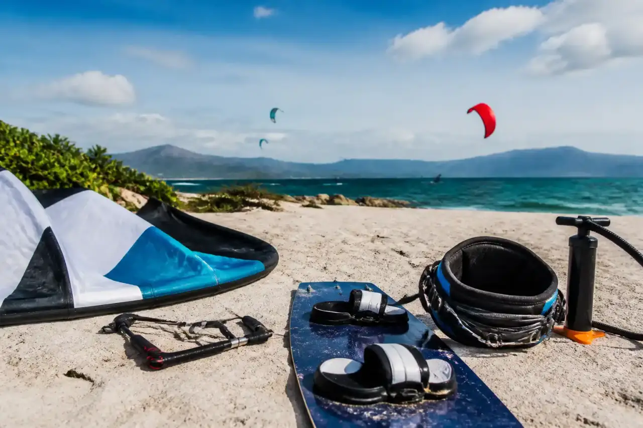 Kitesurfeur préparant sa session face à une mer turquoise et un ciel lumineux